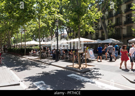 People walking along the street known as La Rambla, Barcelona, Spain Stock Photo