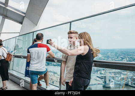 London, UK - June 24, 2018: People taking selfies on an open air balcony in Sky Garden, the highest public garden in London located in a glass dome wi Stock Photo