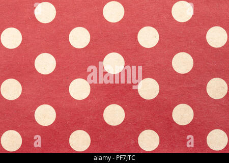 White polka dots on red background, paper surface background Stock Photo