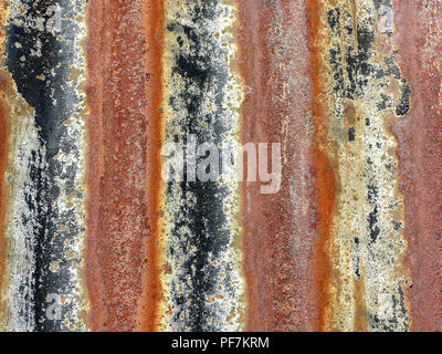 Bands of colour created by rusting corrugated sheet metal with rich red colours and a rough texture. Stock Photo