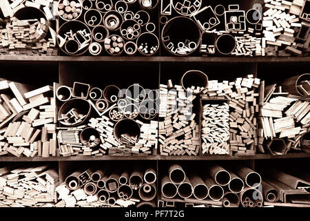 Bars, tubes of various sizes and shapes on shelves Stock Photo