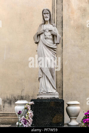 Sepulchral figure of Jesus on grave in Poblenou Cemetery. Stock Photo