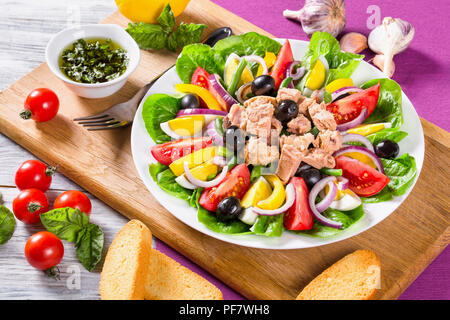 French salad with canned tuna and fresh vegetables and herbs Stock Photo