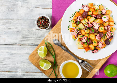 Potato salad with pickled octopus, top view Stock Photo