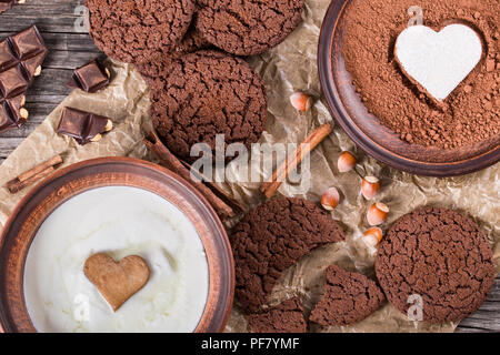 Chocolate cookies, chocolate with hazelnuts on a parchment paper, close-up Stock Photo