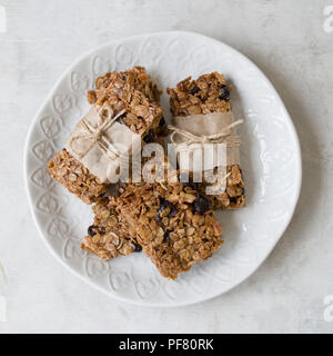 Flapjack - delicious bar with with rye flour, rye flakes and dried cranberry. Homemade Granola Bars. Scandinavian style. Top view Stock Photo