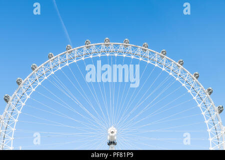 London, UK - June 22, 2018: Closeup view of London Eye center with wires isolated against blue sky ferris wheel spinning Stock Photo