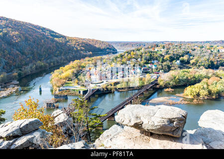 Harper's Ferry overlook with colorful orange yellow foliage during fall, autumn forest with small village town by river in West Virginia, WV Stock Photo