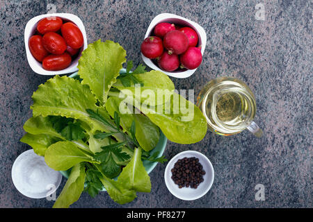 top view on a mixture of fresh leaves, vegetables and spices for summer salad cooking Stock Photo