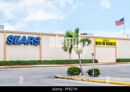 Key West, USA - May 1, 2018: Sears department Store outlet with yellow sign Open for Business with nobody, American flag, road, street Stock Photo
