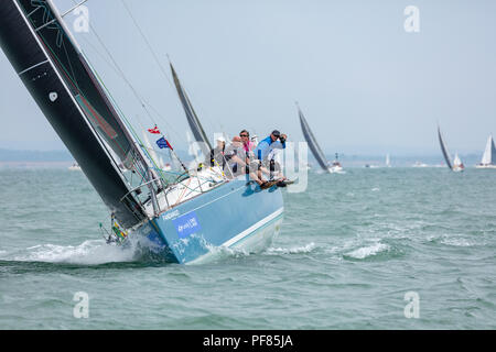 The Solent, Hampshire, UK; 7th August 2018; View Towards Bow of Heeled Yacht Racing at Cowes Week Regatta With Crew Seated on Side of Boat Stock Photo