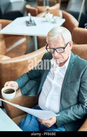 Modern Senior Businessman Working in Cafe Stock Photo