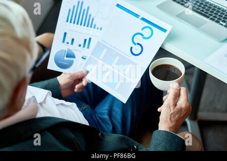 Unrecognizable Senior Businessman Working in Cafe Stock Photo