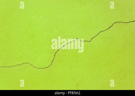Simple crack in the middle of a green old wall Stock Photo