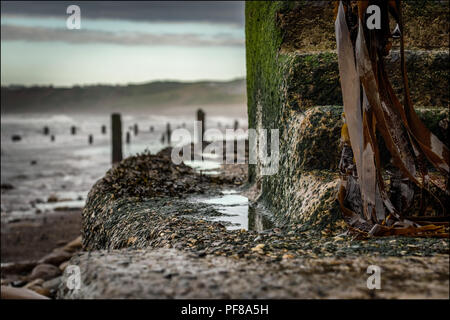 Old stone steps leading down to the beach at Sandsend, North Yorkshire. Stock Photo