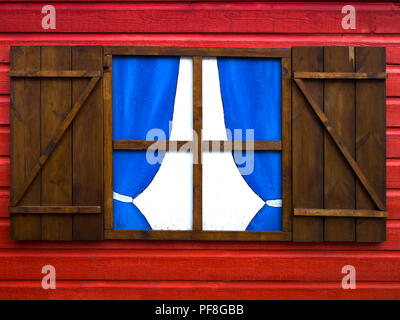 Close up on a window and door of a cabin in red wood Stock Photo