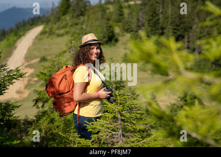 Young tourist woman taking a photo of landscape. Stock Photo
