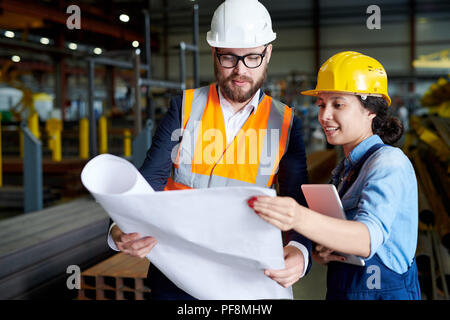 Engineers Studying Plans Stock Photo