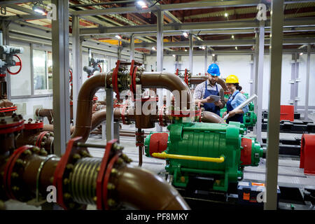 Two Workers in Water Purification System Stock Photo