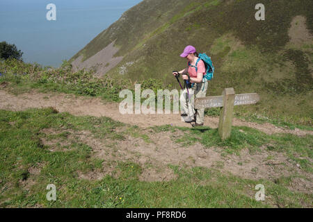 Lone Woman Walking on the Rugged Path of South West Coastal Path, Somerset, England, UK. Stock Photo