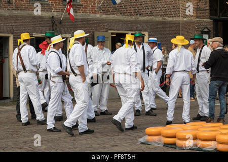 Alkmaar, Netherlands - June 01, 2018: Group of cheese carriers in front of the Waag building waiting for the start of the cheese market Stock Photo