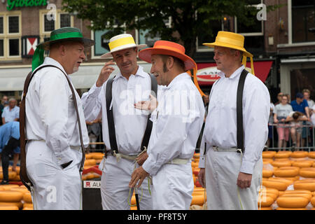 Alkmaar, Netherlands - June 01, 2018: Group of cheese carriers talking before the starts of the cheese market Stock Photo