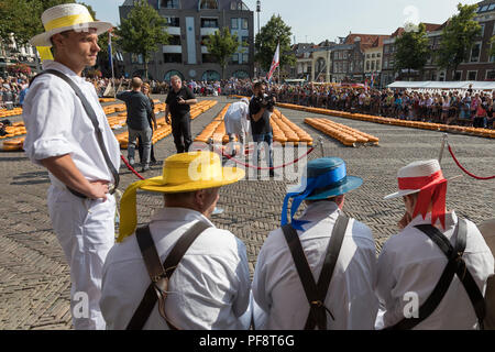 Alkmaar, Netherlands - July 20, 2018: Group of cheese carriers in front of the Waag building waiting for the start of the cheese market Stock Photo