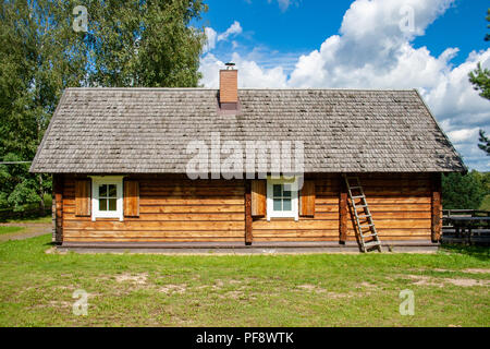 Old lithuanian wooden house in Vilnius, Lithuania with sky and nature Stock Photo