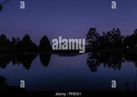 An evening dusk dark landscape of an unknown lake in Underberg near Sani pass in an accommodation called Meadow Lane country cottages Stock Photo