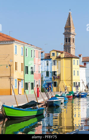 Sunset in the colourful fishing village on Burano Island, Venice, Veneto, Italy, Leaning bell tower and reflections on the canal Stock Photo