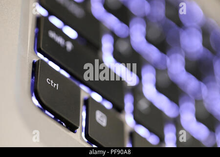 close up of the ctrl tab. The control key symbol button on an illuminated laptop computer keyboard. Stock Photo