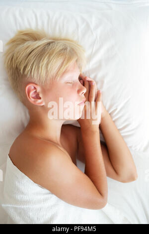 Blondy boy sleeping in bed. Sweet dream concept. Top view. Stock Photo