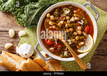 Stewed kale cabbage with chickpeas and vegetables close-up on the table. horizontal top view from above Stock Photo