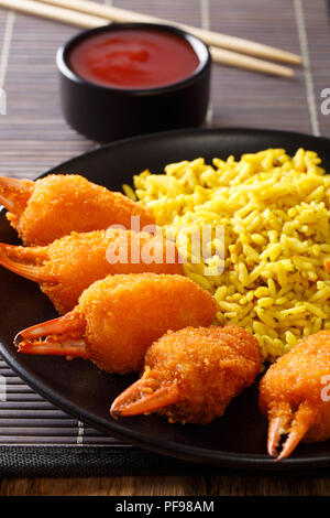 Fried crab claws tempura with rice close-up on a plate on the table. vertical Stock Photo