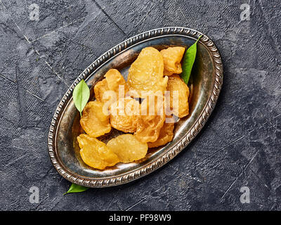 Dried pear, apricot or peach on black background. Top view of candied fruits. Stock Photo