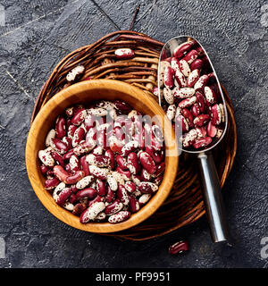 Red beans with white spots on black background. Top view. Stock Photo