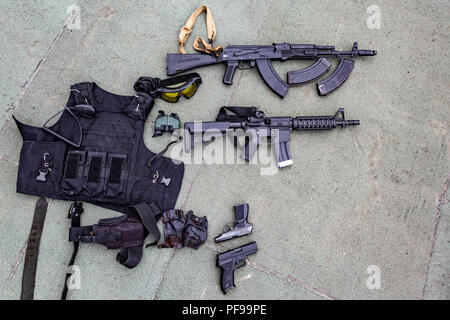 Weapons on the ground. Rifles pistols guns body armor Stock Photo