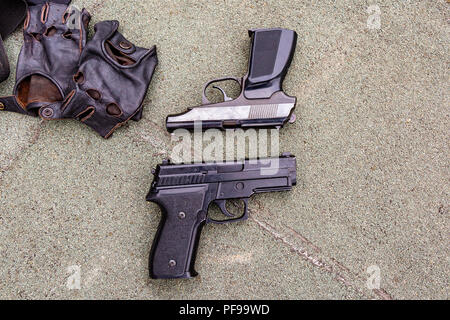 Weapons on the ground. Rifles pistols guns body armor Stock Photo