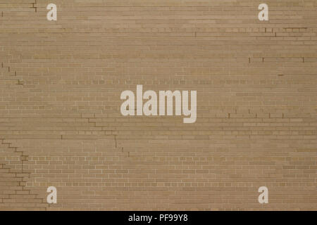 Attractive weathered light grey or beige brick wall background with a Scottish bond brickwork pattern Stock Photo