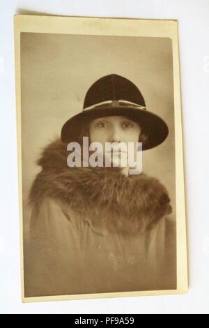 Social History - Black and white old photograph showing a beautiful young girl aged 19 wearing a hat and fur collared coat - 1930s / 1940s Stock Photo