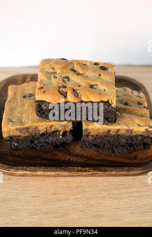Brookie Brownie Cookie Dessert Combo Stacked on a Wooden Plate for a Treat Stock Photo