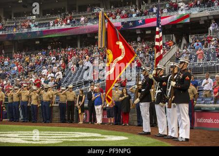 Marines with the US Marine Corps Color Guard present the National Ensign during the playing of the National Anthem at US Marine Corps Day at Nationals Park, Washington DC, July 31, 2018. Image courtesy Sgt. Robert Knapp/Marine Barracks Washington, 8th. () Stock Photo