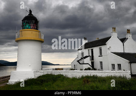 White Corran Lighthouse and Lodge under dark clouds in Ardgour Isle of Mull on the shore of Loch Linnhe Scotland UK Stock Photo