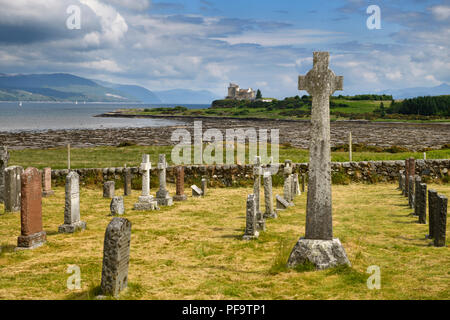 Ancient tombstones and Celtic cross at Kilpatrick Cemetery next to Duart Castle on Isle of Mull on Sound of Mull Loch Linnhe Scotland UK Stock Photo