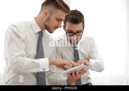 close up.two employees looking at the digital tablet screen Stock Photo
