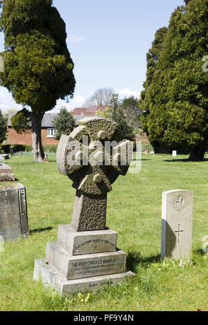 Winslow, UK - April 27, 2015. Gravestone with cross at a church graveyard in the historic town of Winslow, Buckinghamshire Stock Photo