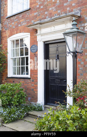 Winslow, UK - April 27, 2015. Front door and entrance way to a traditional historic British brick house in the historic market town of Winslow Stock Photo