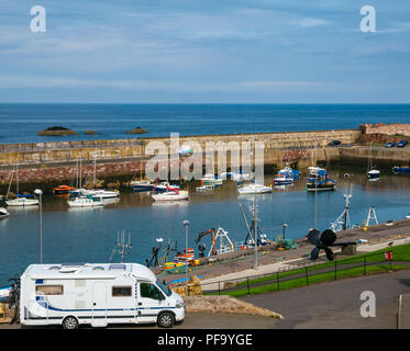 View of fishing boats in Dunbar harbour with parked motorhome, Dunbar, East Lothian, Scotland, UK Stock Photo