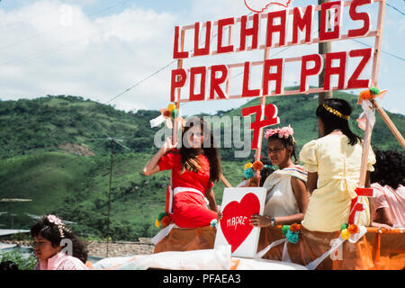 Esteli, Nicaragua, July 1986; On the 7th aniversary of the overthrow of Somoza a procession takes place to remember those killed in the conflict. The banner says 'We fight for peace'. Stock Photo