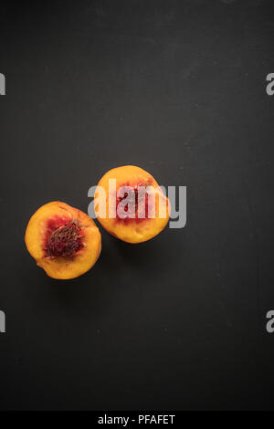 half peach on black background Stock Photo